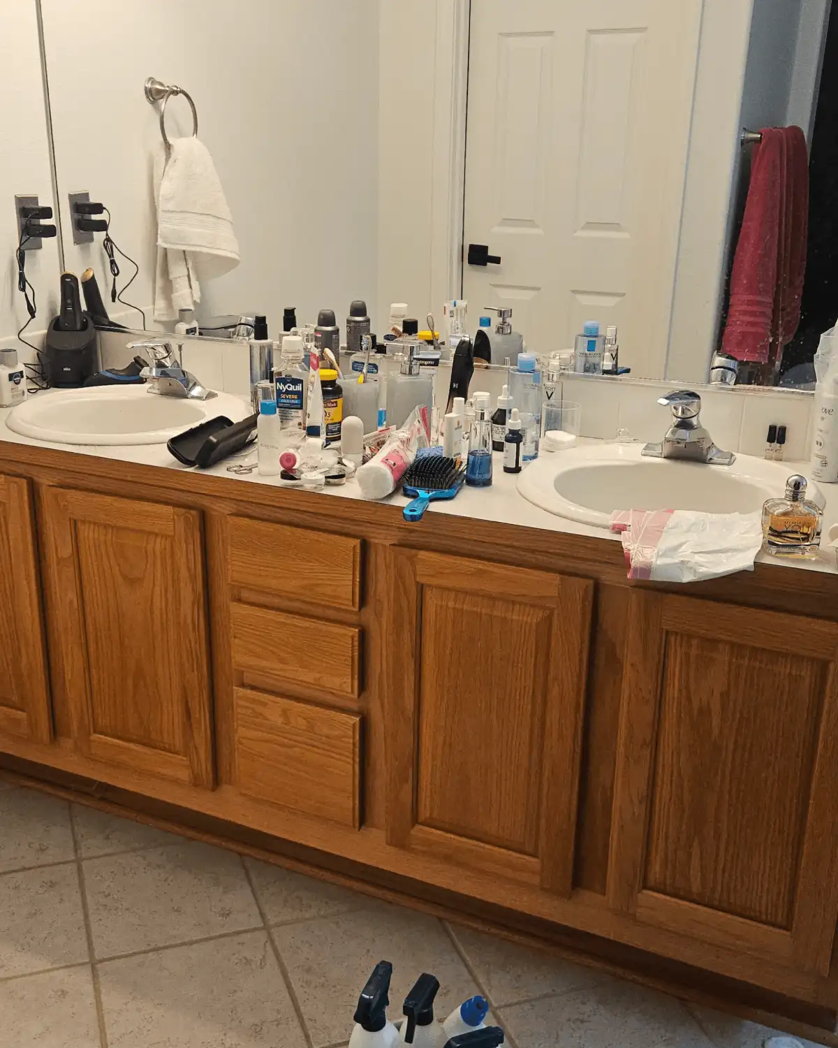 Before photo of a bathroom vanity and mirror before a Clary Clean deep bathroom reset