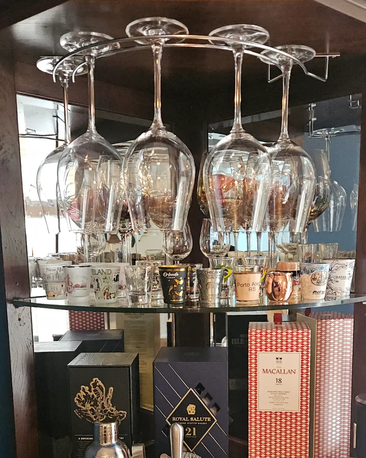 After photo of a china cabinet and wine glasses shining after careful hand cleaning by Clary Clean