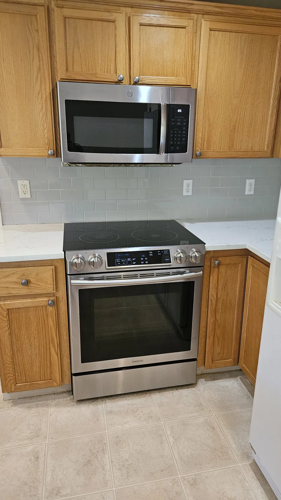 Clean oven, microwave, and backsplash area prepared for move-out handoff by Clary Clean